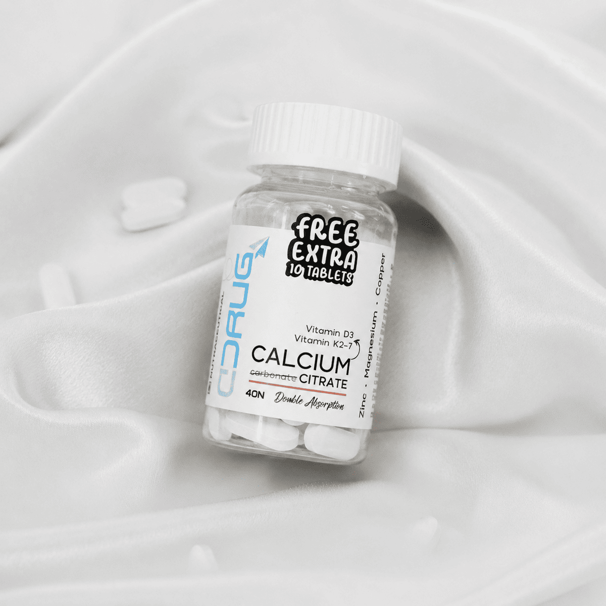 Bottle of Calcium Citrate supplement with a white label on a white Silk Cloth background. Calcium Citrate Tablets 40N, with Zinc, Magnesium, Copper, Vitamin D3 & Vitamin K2-7. With Free 10 Tablets.